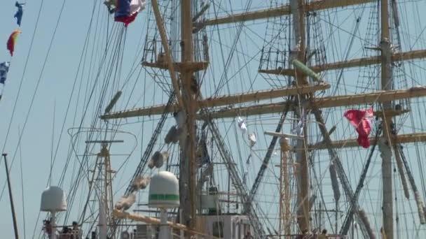 The view from the superstructure to the mast of a large sailing ship standing on the docks of the port — Stock Video