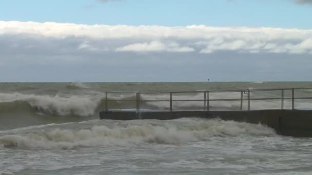 Waves breaking on the pier on the seafront promenade during a storm in the Black Sea — Stock Video