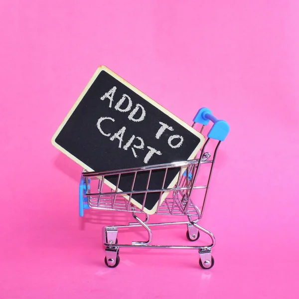 Bevásárlókocsi Szöveges Add Cart Rózsaszín Háttér — Stock Fotó