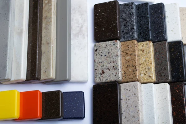 Samples of natural granite, marble and quartz stone, countertops. Model from stones, close-up. Modern colored slabs made of natural stone.