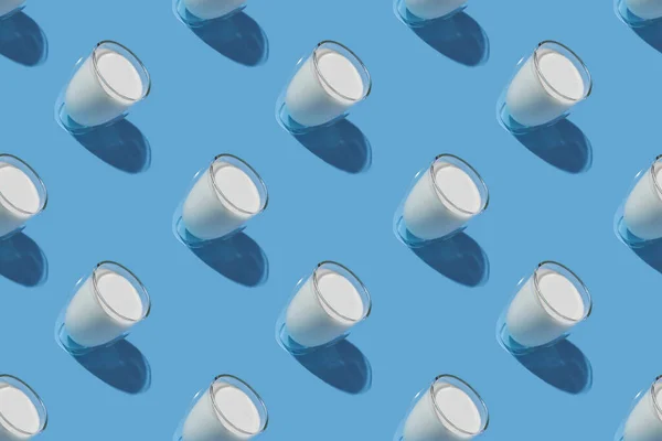 World Milk Day. Pattern on a blue background. A glass of milk. Pattern.