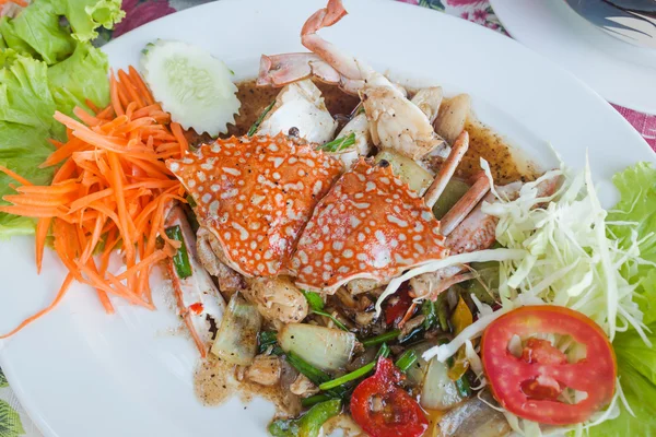 Beyaz tabak kızarmış deniz Yengeç karabiber ile karıştırın.