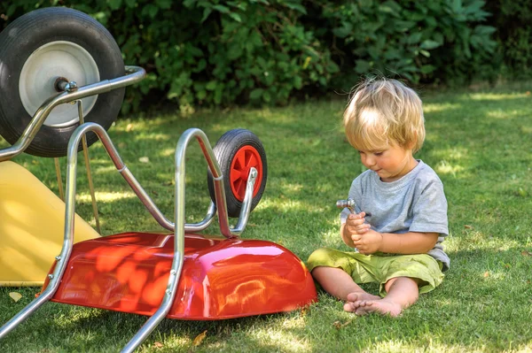 Small boy plays with ratchet — Stock Photo, Image