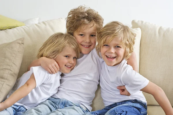 Three brothers on sofa — Stock Photo, Image