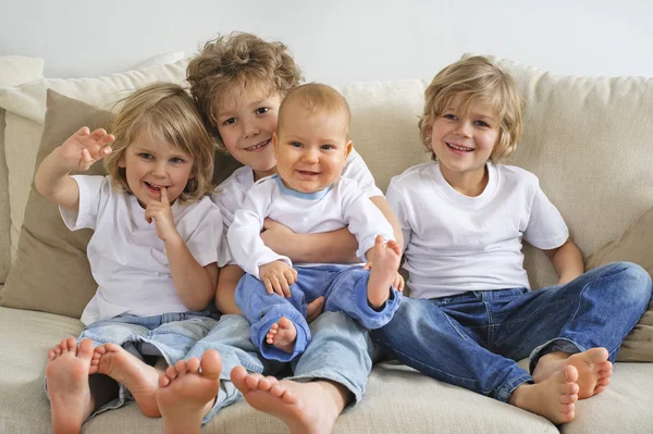 Four brothers on a sofa — Stock Photo, Image