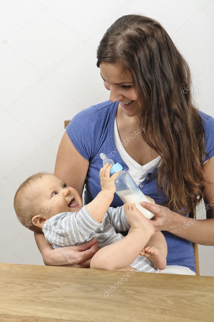 mother bottle feeding baby