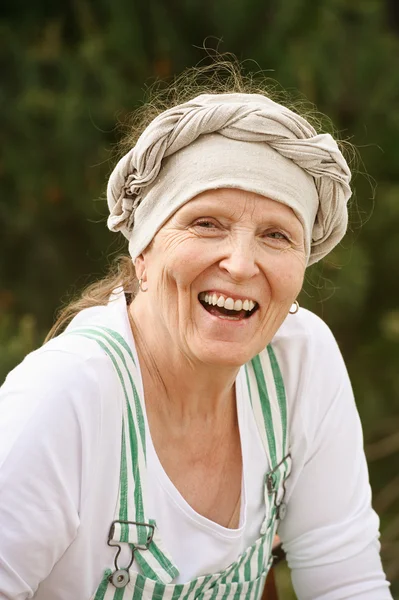 Senior woman laughing outdoors — Stock Photo, Image