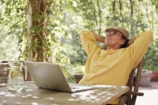 Senior man outdoors with laptop Stock Picture