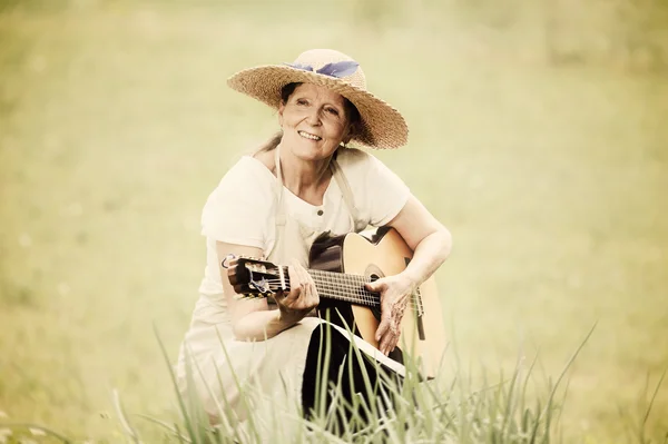 Açık havada gitar ile üst düzey kadın — Stok fotoğraf