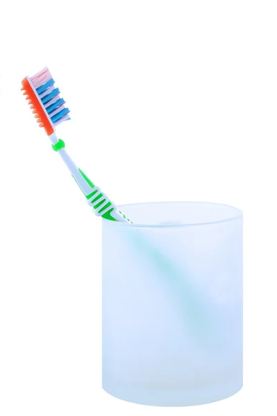 Green tooth brush in glass. — Stock Photo, Image