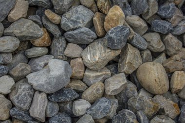 Bir sürü büyük renkli çakıl taşı var. mavi, beyaz ve gri taşlar bir yığın