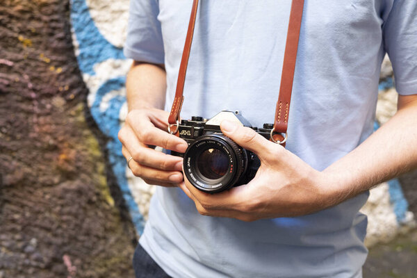 Saint Petersburg, Russia - 27.08.2020: vintage black camera close-up in the hands of a man