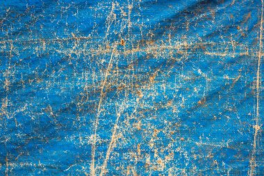 Katları ve delikleri kapalı eski püskü mavi tuval. kabaca yüzey dokusu