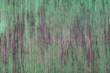 Yeşil boyası ve çatlağı olan eski gri ahşap tahta. kaba doku yüzeyi. dikey çizgiler