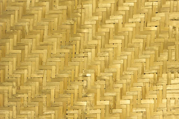 yellow dry sheet woven from bamboo. natural surface texture. vertical and horizontal lines
