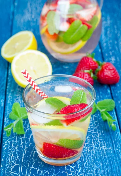 Strawberry mint homemade lemonade on blue wooden table — Stock Photo, Image