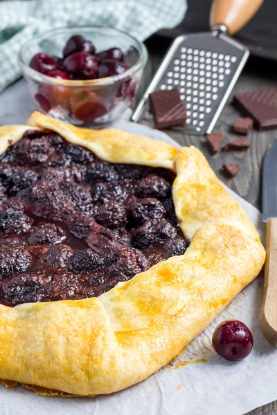 Cottage cheese dough galette with cherries and chocolate, vertical