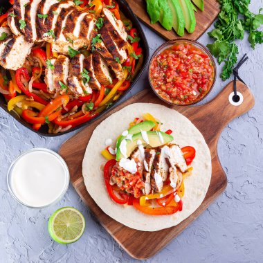 Biberli tavuk Fajitas, soğan, salsa Asada, avokado ve ekşi krema yumuşak tortilla, Güneybatı Tex-Mex Mutfağı, üst manzara, kare format