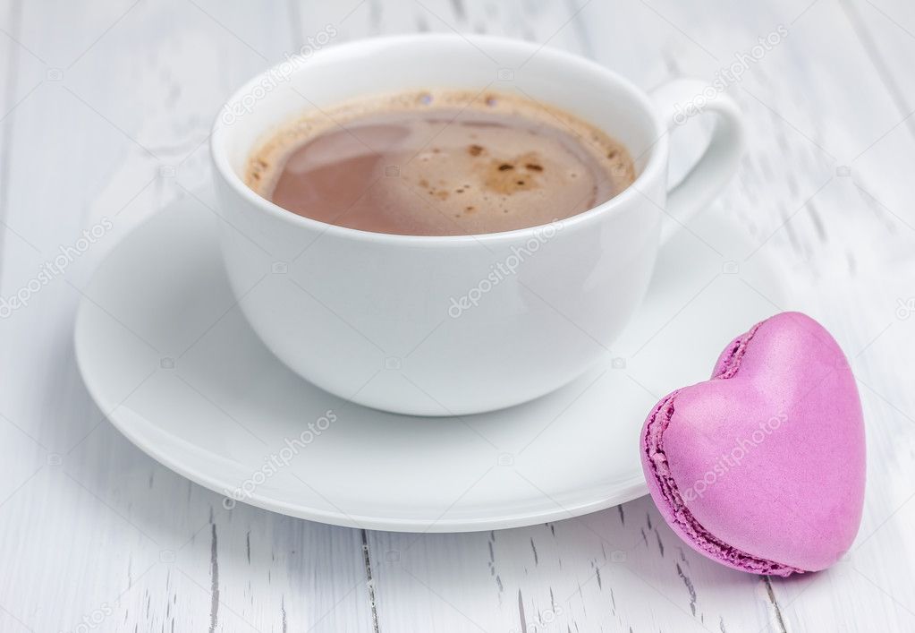 A cup of hot chocolate with a  heart-shaped macaron (horizontal)