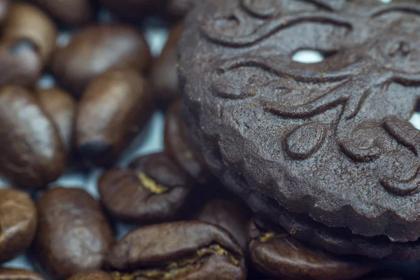 Granos de café y galletas de chocolate de cerca, enfoque selectivo — Foto de Stock