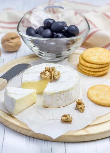 Queijo brie macio com bolachas nozes e azeitonas — Fotografia de Stock