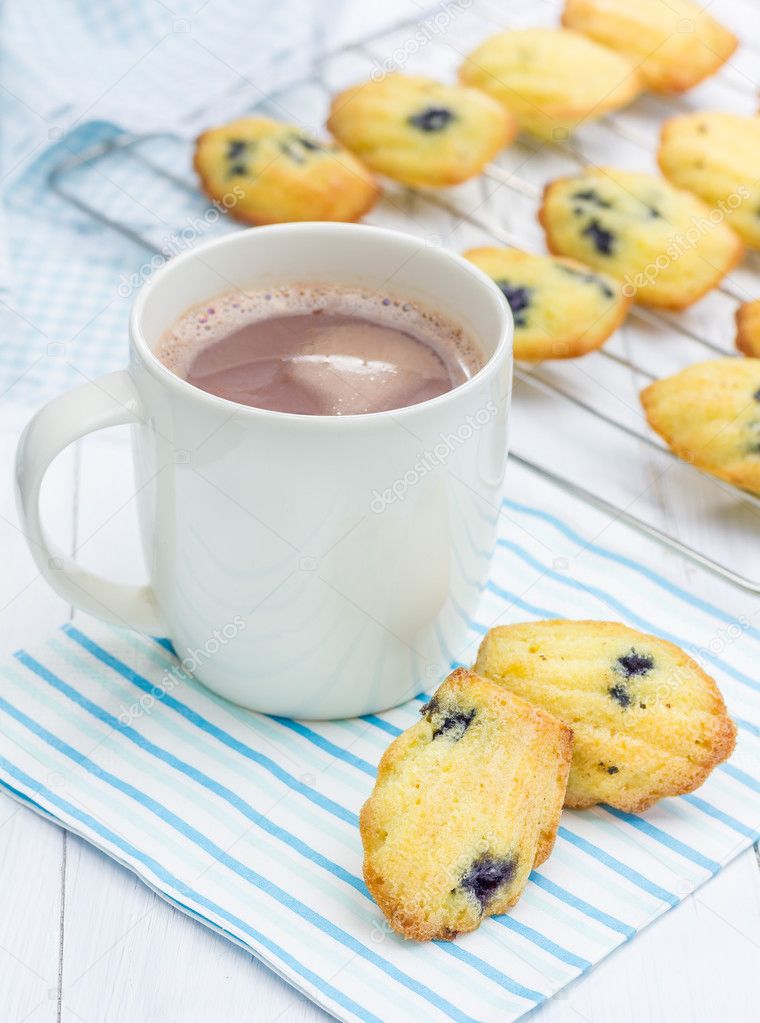 Madeleines with blueberries and a cup of hot chocolate