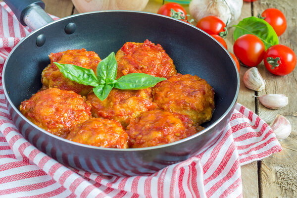 Meatballs with tomato sauce in frying pan