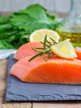 Fresh raw salmon fillet with rosemary and lemon