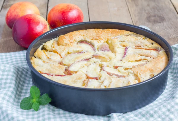 Peach clafoutis in a baking dish — Stock Photo, Image