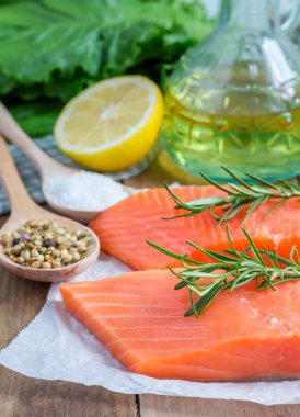 Fresh raw salmon fillet with rosemary and lemon