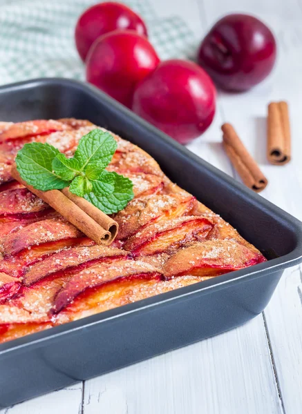 Homemade plum pie in a baking dish — ストック写真