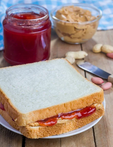 Sandwich with creamy peanut butter and strawberry jam Royalty Free Stock Photos
