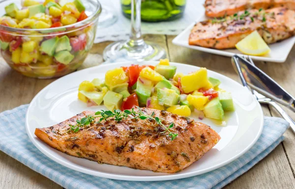 Salmão grelhado com especiarias com salsa de manga-abacate em um prato branco — Fotografia de Stock