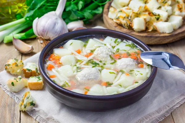 Homemade soup with meatballs and vegetables, served with cheese-garlic-parsley croutons — Stock Photo, Image
