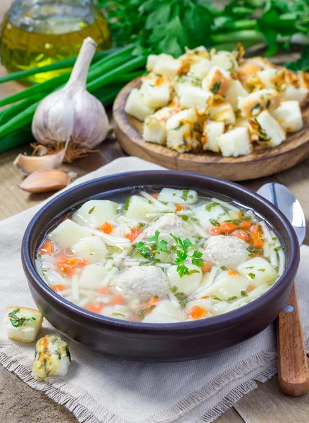 Homemade soup with meatballs and vegetables, served with cheese-garlic-parsley croutons — Stock Photo, Image