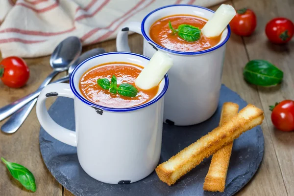 Homemade tomato basil soup in the mug, served with mozzarella cheese stick and croutons — Stock Photo, Image