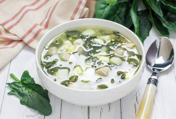 Healthy green soup with spinach meat, potato and egg (green borscht)