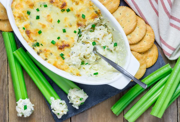 Upečené krabí dip, podávaný s brček a sušenky — Stock fotografie