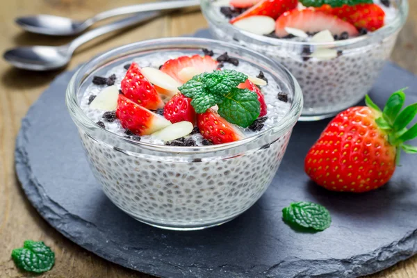 Chia seed pudding with strawberries, almond and chocolate cookie crumbs