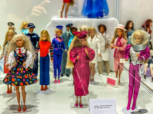 Darmstadt, Germany - September 16th 2020: A german photographer visiting Loop5, the biggest shopping mall in Hesse, taking pictures of an exhibition with different barbie dolls from 30 decades.