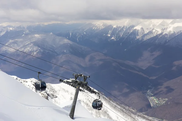 Rosa Khutor, Rusko - 31 březen 2016: Scenérie horských pohled shora od Rosa Peak a kabelové lyžařské výtah — Stock fotografie