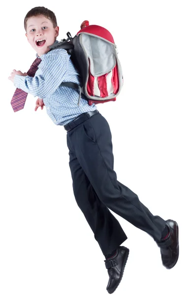 Молодой школьник со школьной сумкой в спешке — стоковое фото