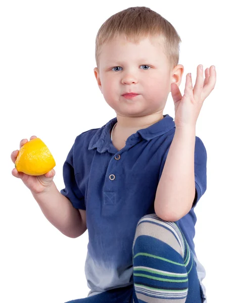 Bonito menino comendo limão — Fotografia de Stock