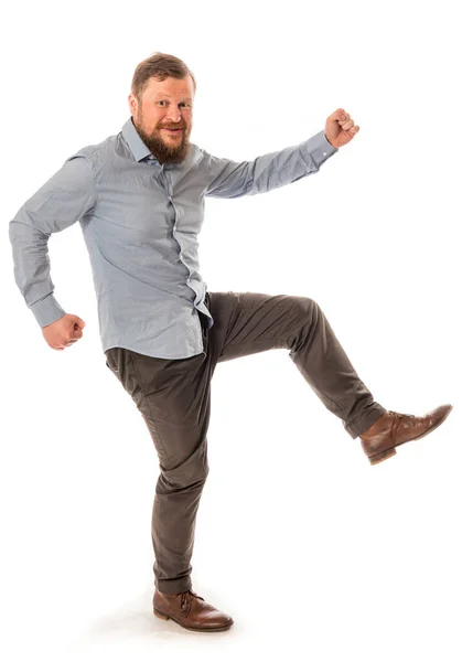 Joyful bearded man in shirt stepping studio portrait on white background. — Stock Photo, Image