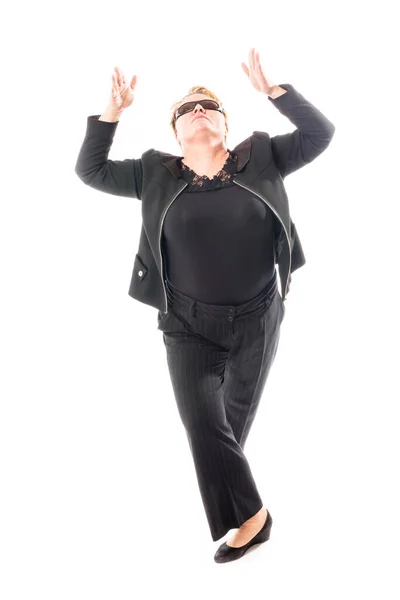 Middle aged woman in black jacket and trousers dancing an emotional dance — Stock Photo, Image