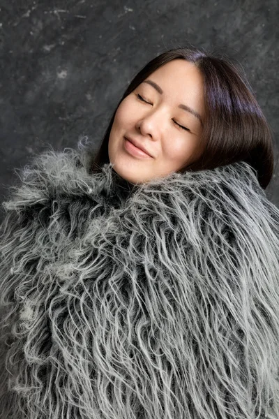 Beautiful korean woman dressed in fur mantle