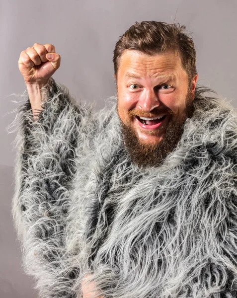 Solid bearded man in a fur mantle studio emotional