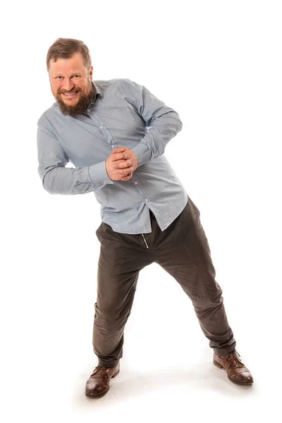Radostný vousatý muž v košili tlačí neviditelnou zeď — Stock fotografie