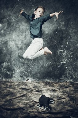 Beyaz kot ve mavi gömlek giymiş genç bir artistik patenci.