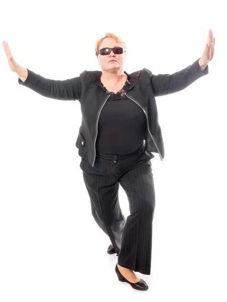 Middle aged woman in black jacket and trousers dancing an emotional dance — Stock Photo, Image